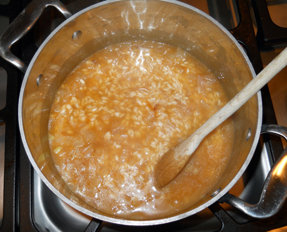 Risotto simmering in chicken broth