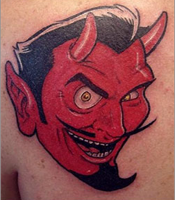 Tattoo art of red devil on shoulder