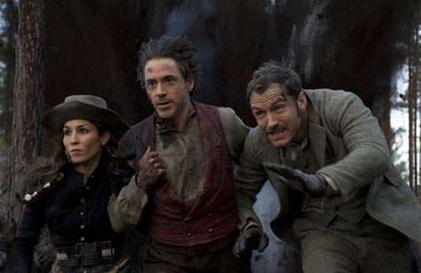 Noomi Rapace as Madame Simza, Robert Downey Jr,. and Jude Law as Sherlock and Watson: They escape. The forest? Not so lucky.