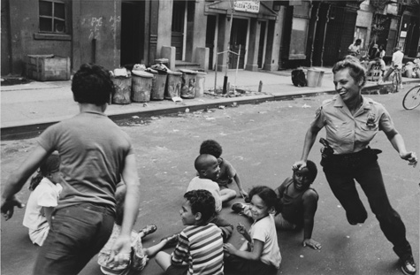 A policewoman plays with local kids in Harlem, 1978, Leonard Freed