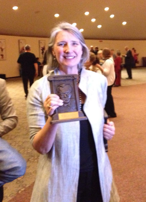 Louise Penny holding her 2013 Anthony Award for Best Novel: She was entirely in focus. The photographer...?
