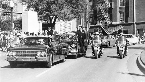 John F. Kennedy's motorcade on Elm St. in Dallas as it passes the Texas School Book Depository